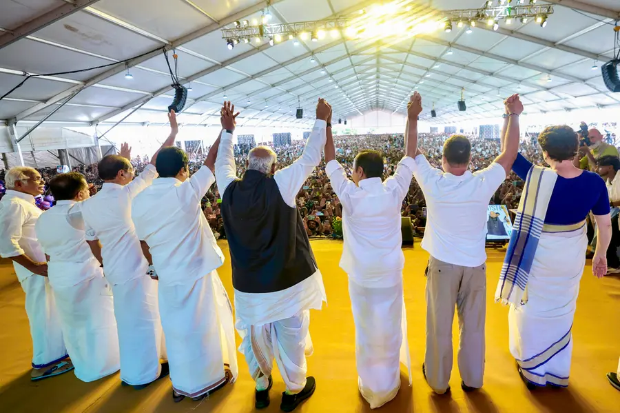 Congress leaders join hands during the swearing-in ceremony of the Kerala government