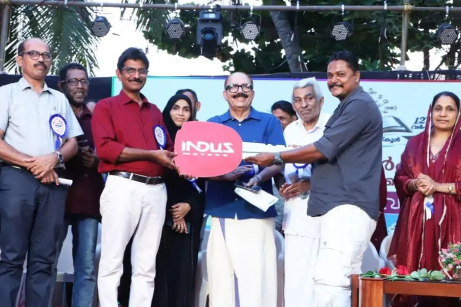 Retiring headmaster PT Benni being presented with the keys to a brand new Maruti Brezza car by the school committee and local residents in Kasaragod