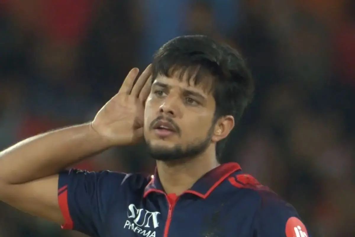 Rasikh Salam Dar celebrates after clean bowling Travis Head during the IPL 2026 clash between Royal Challengers Bengaluru and Sunrisers Hyderabad as Virat Kohli reacts passionately from the field.