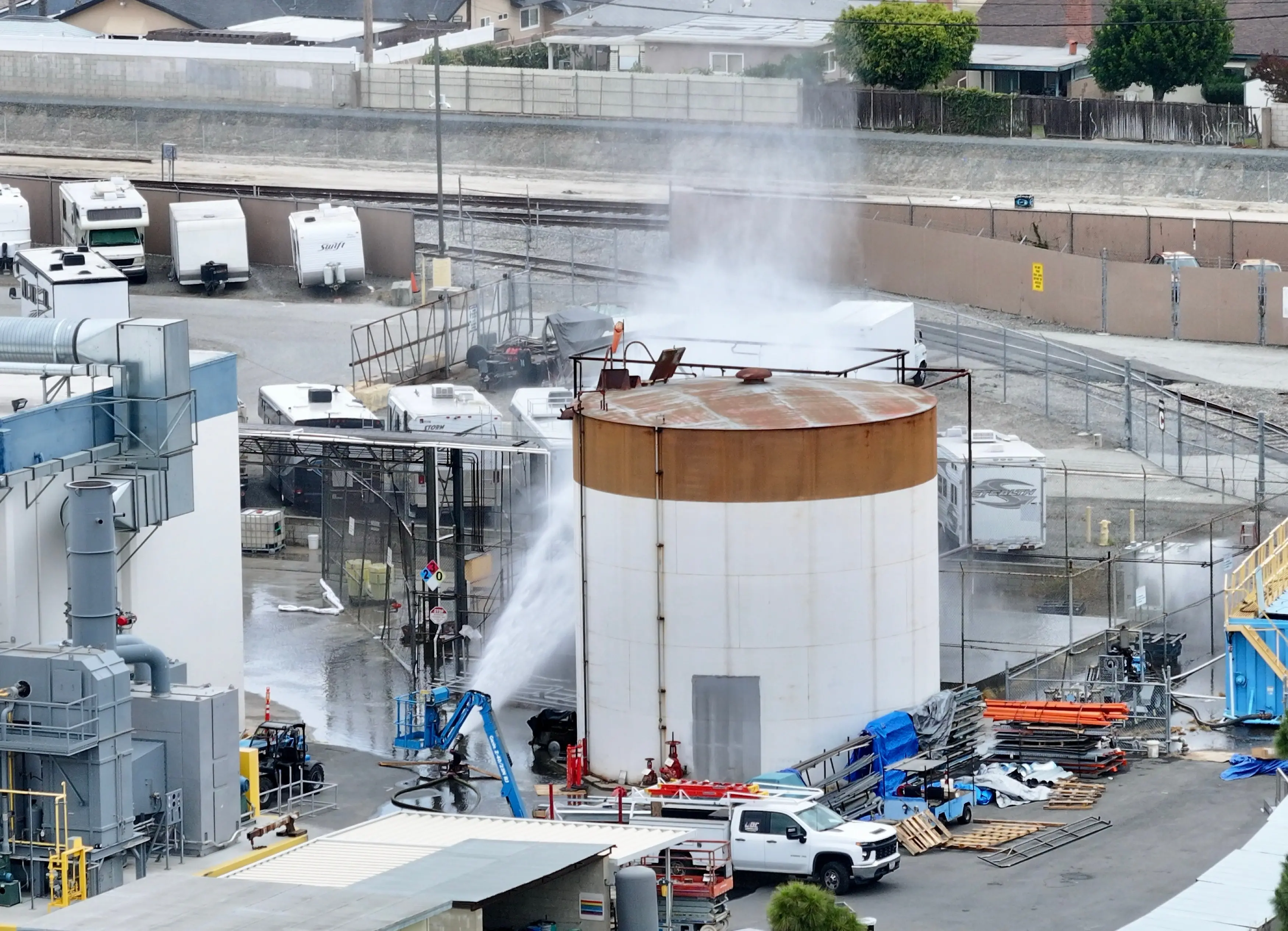 Water is sprayed on a tank that overheated at an aerospace plant in Garden Grove, Calif., Friday | AP