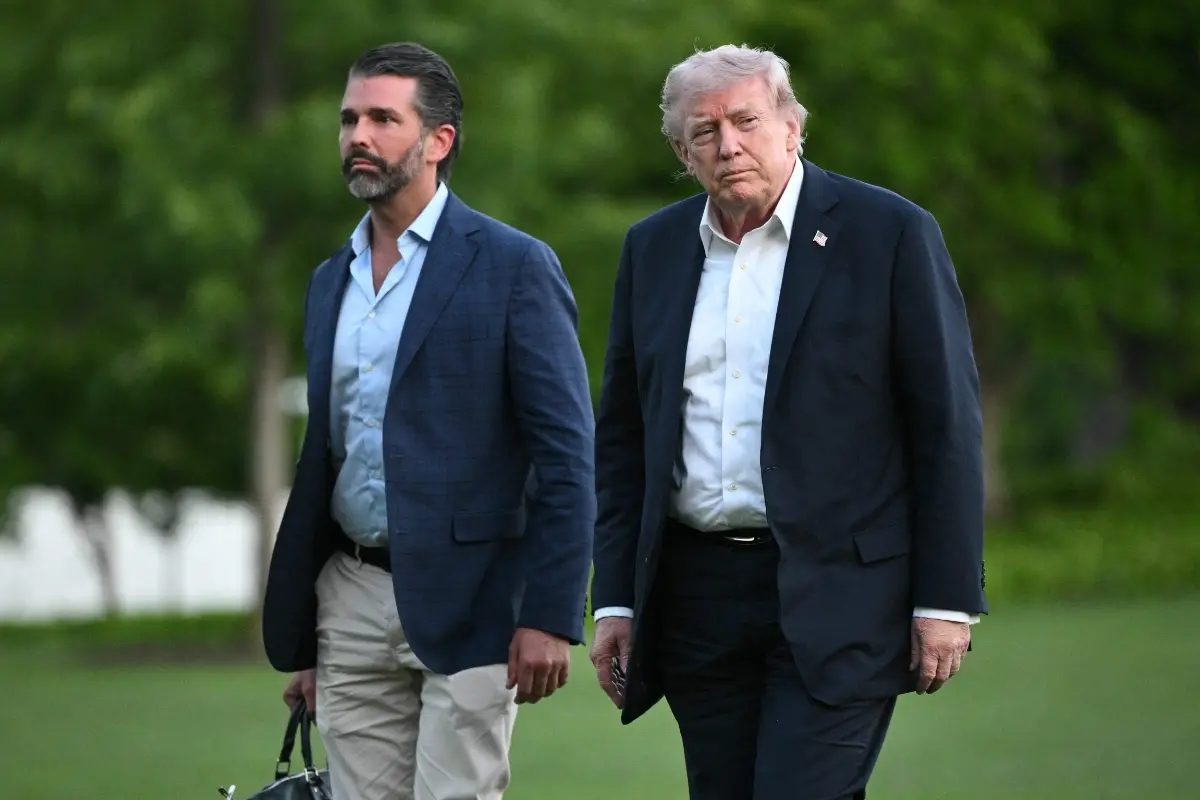 US President Donald Trump and Donald Trump Jr. walk on the south lawn toward the White House in Washington, DC.| File image: AFP