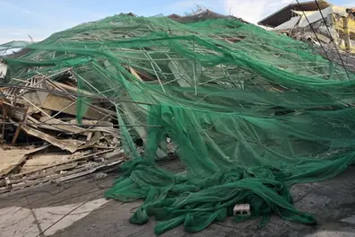 19 feared trapped after building collapse near Manila