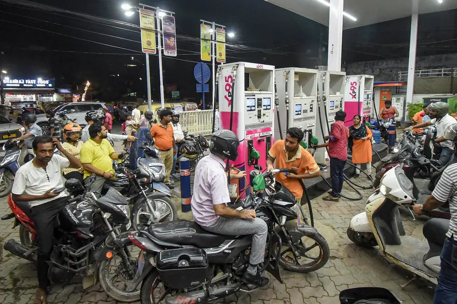 Consumers wait at a petrol station amid multiple hikes in fuel prices