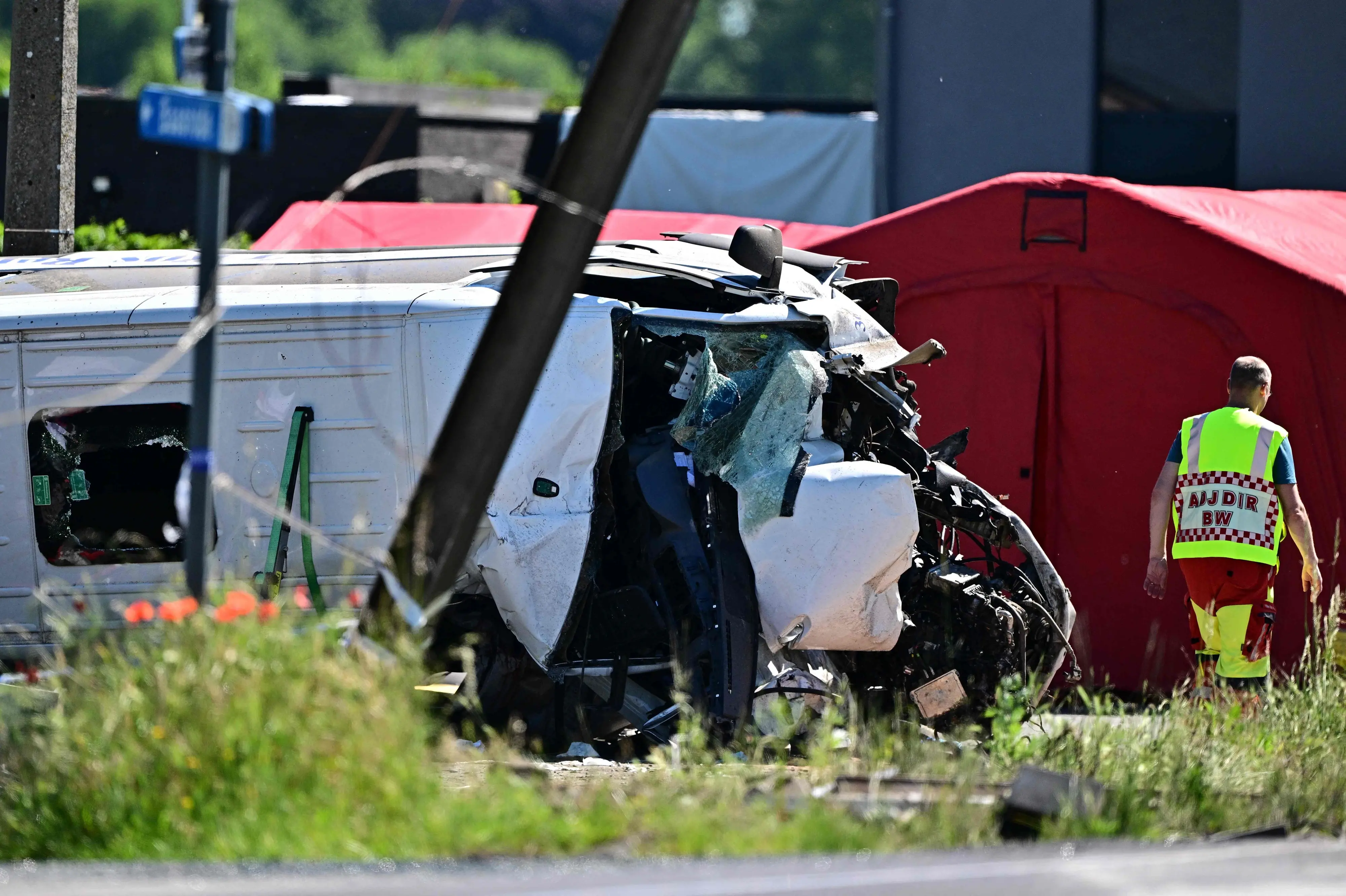 A damaged train car at the site of an accident after a train crashed into a school bus | Photo: AFP