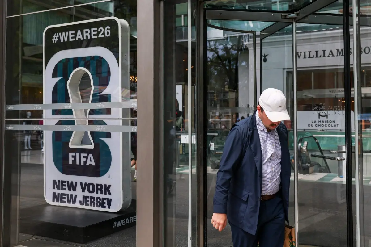 A person walks past signage for the FIFA 2026 World Cup at a shopping mall in New York | Photo: AFP