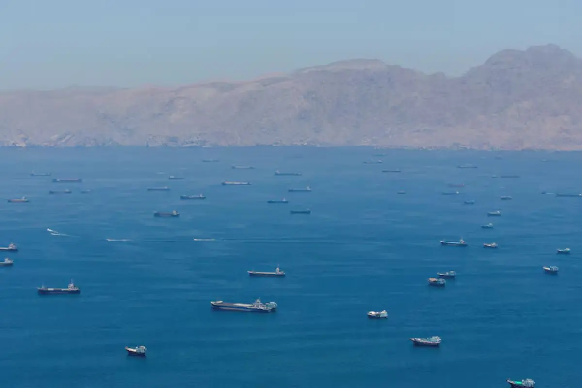 Commercial vessels seen near the Strait of Hormuz amid rising tensions between Iran and the United States following fresh military strikes in the Gulf region.