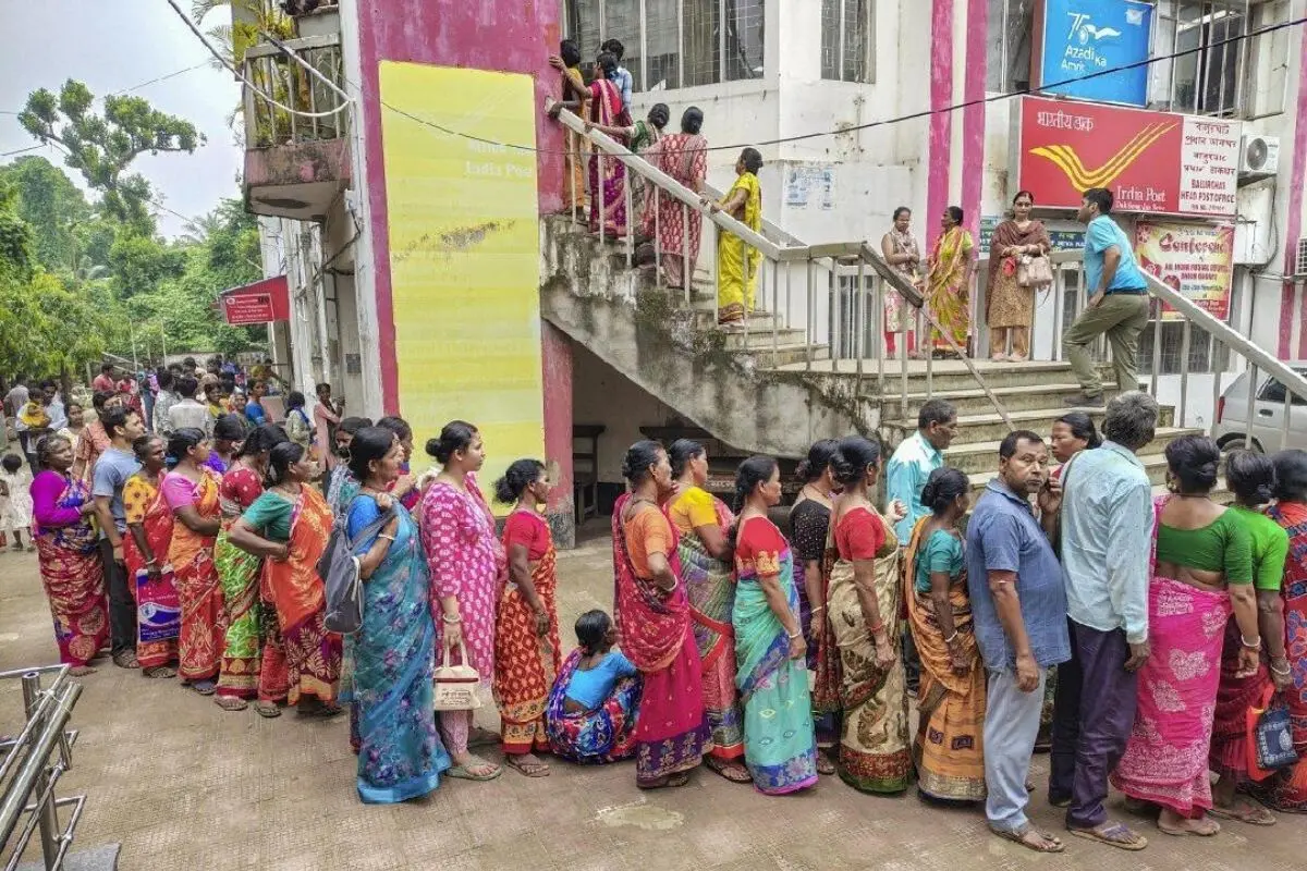 Women queue up outside a government office to collect and submit application forms for the Annapurna Bhandar scheme as the enrolment process begins in West Bengal.