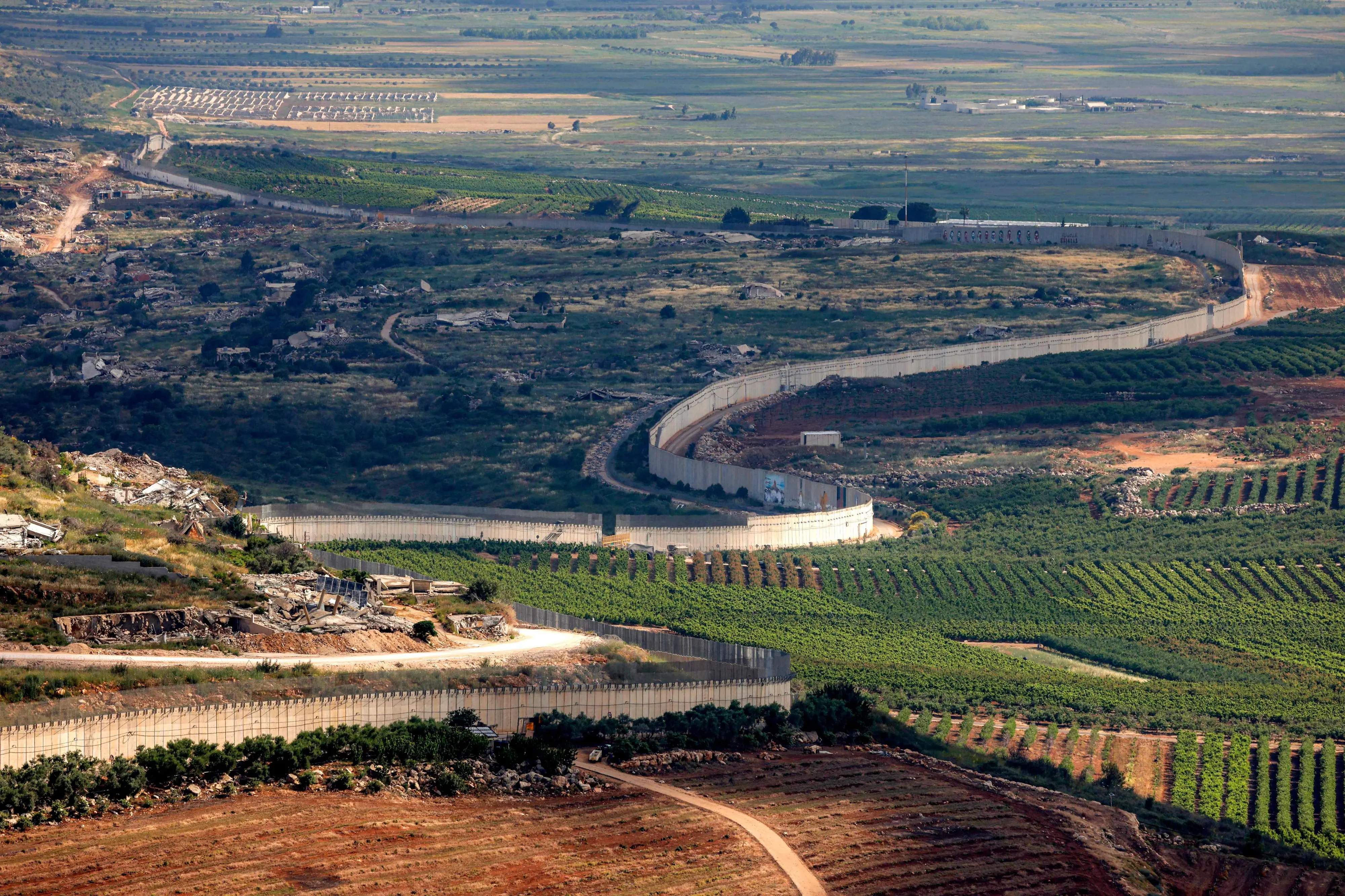 The border wall separating Israel (R) and Lebanon is pictured from a position along the Upper Galilee region of northern Israel | AFP