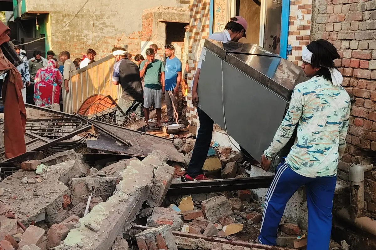 People take out their belongings after a demolition drive was carried out by Faridabad administration and Municipal Corporation (MCF) to remove several alleged illegal structures, at Sainik Colony Chowk, in Faridabad.| Photo: PTI