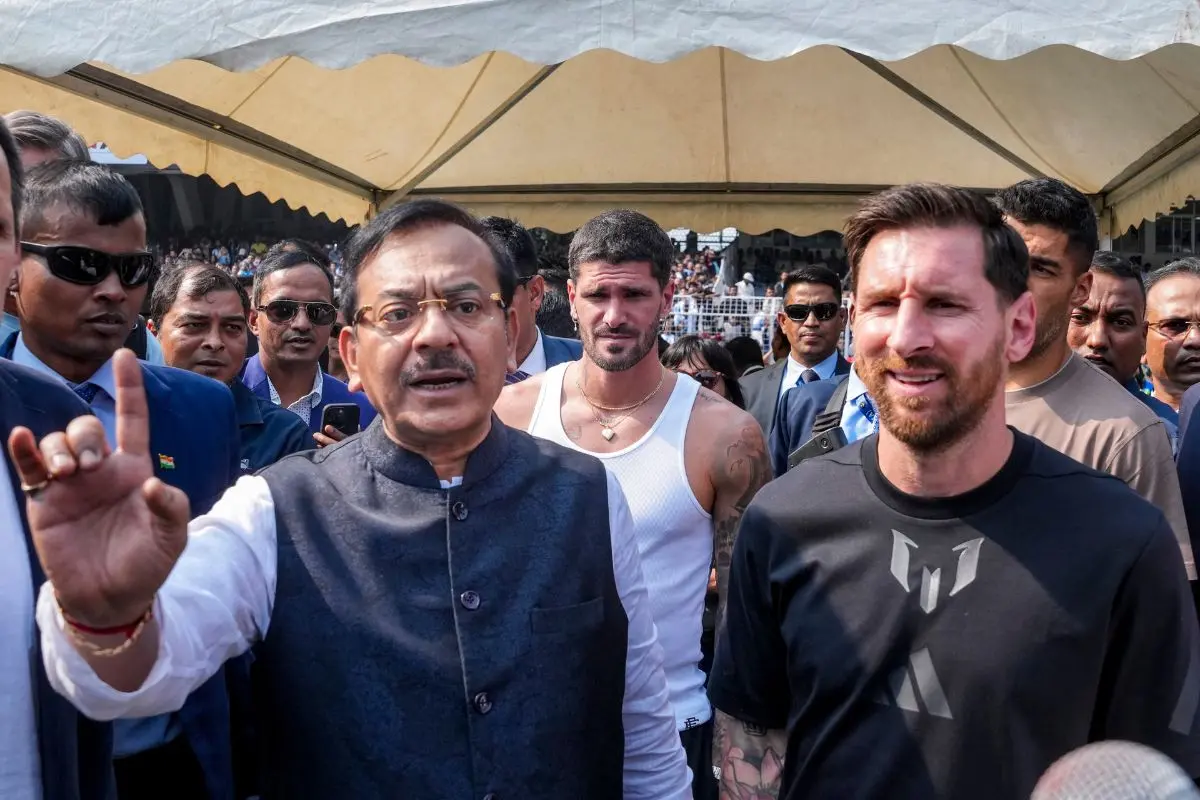 Argentine footballer Lionel Messi with West Bengal Sports Minister Aroop Biswas, right, during an event as part of his 'G.O.A.T. India Tour 2025', at Vivekananda Yuba Bharati Krirangan (VYBK), in Kolkata, Saturday, Dec. 13, 2025. (PTI Photo/Swapan Mahapatra)