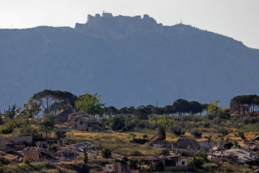 buildings in the southern Lebanon against the backdrop of the medieval Beaufort Castle, locally known as Qalaat al-Shaqif or Shaqif Arnoun