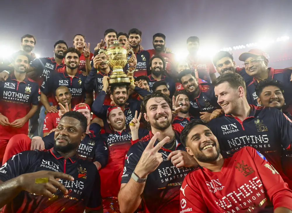 Royal Challengers Bengaluru players celebrate with the trophy after winning the Indian Premier League 2026 Final match against Gujarat Titans at Narendra Modi Stadium, in Ahmedabad on Sunday | ANI