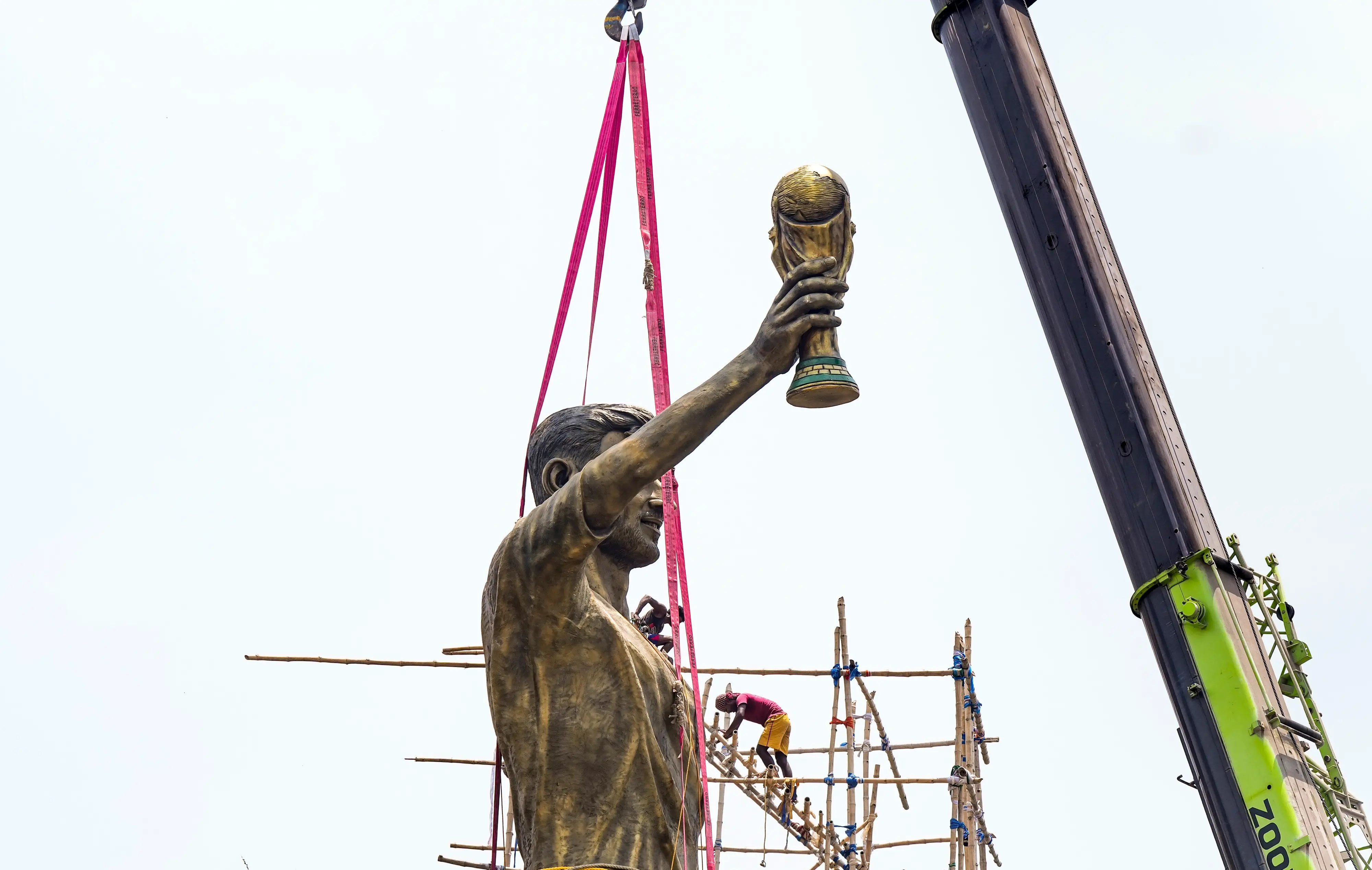 PWD workers use a crane to dismantle a statue of Argentine footballer Lionel Messi in Kolkata | PTI