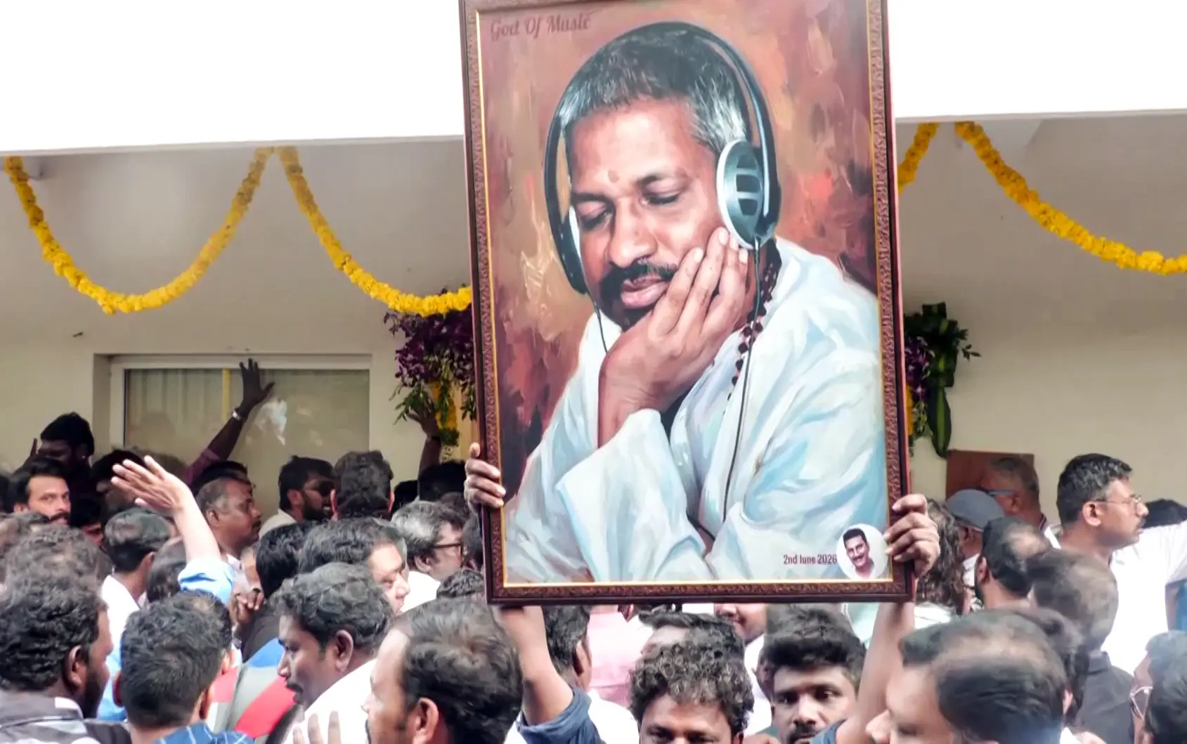 A fan holds the portrait of music composer Ilaiyaraaja on his birthday outside his Kodambakkam office | ANI