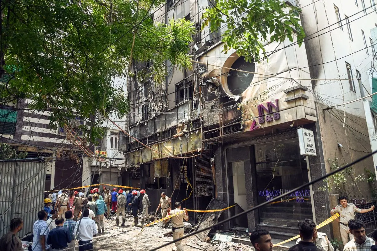 Media personnel at the site where a fire broke out in a restaurant at Malviya Nagar, in New Delhi on Wednesday. (ANI Photo/Sumit)
