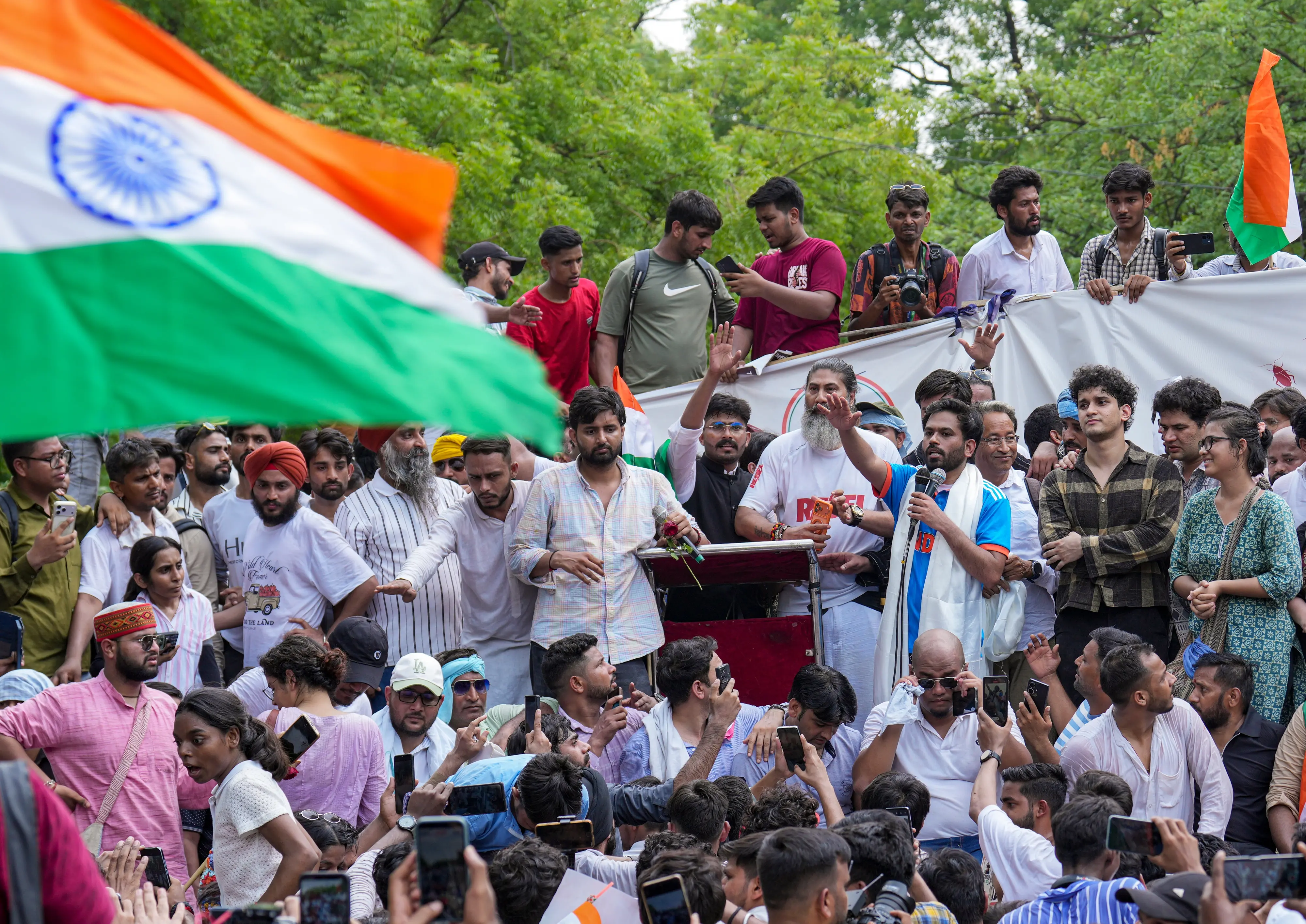 Cockroach Janta Party (CJP) founder Abhijeet Dipke, in blue, its spokesperson Saurav Das, and Climate activist Sonam Wangchuk during a protest demanding the resignation of Union Education Minister Dharmendra Pradhan over alleged examination-related lapses, at the Jantar Mantar, in New Delhi, Saturday, June 6, 2026. (PTI Photo/Karma Bhutia)