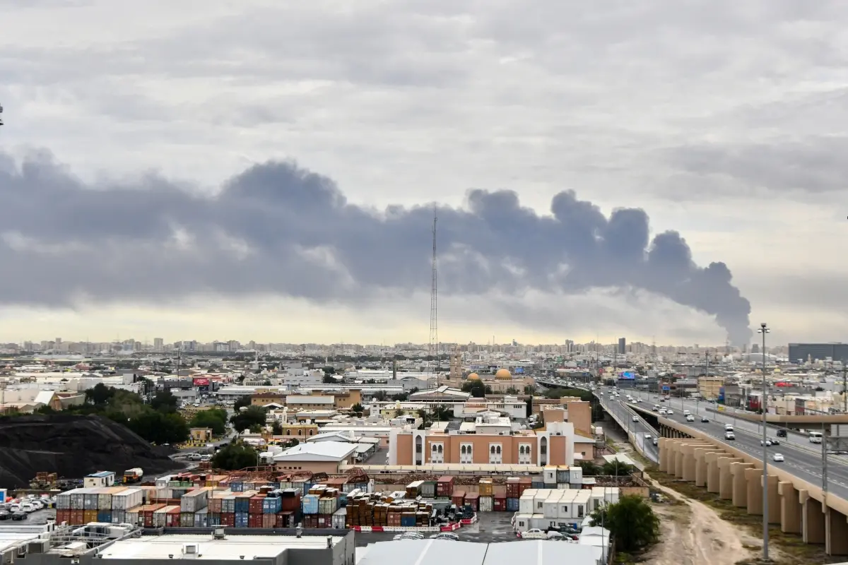 Smoke rises from Kuwait international airport after a drone strike on fuel storage in Kuwait City, Kuwait.| Photo: AP