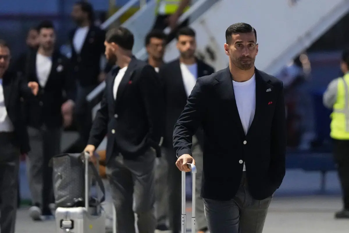 Iran's Ehsan Hajisafi, right, arrives with his teammates for the World Cup soccer tournament in Tijuana, Mexico.| Photo: AP