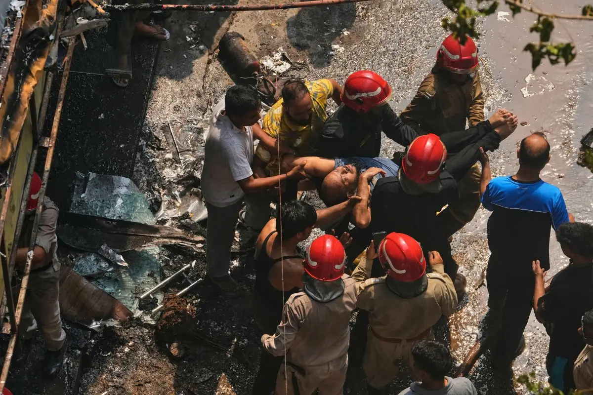 Firefighters rescue a foreign national from a hotel fire in New Delhi, India, Wednesday, June 3, 2026. (AP Photo/Manish Swarup)