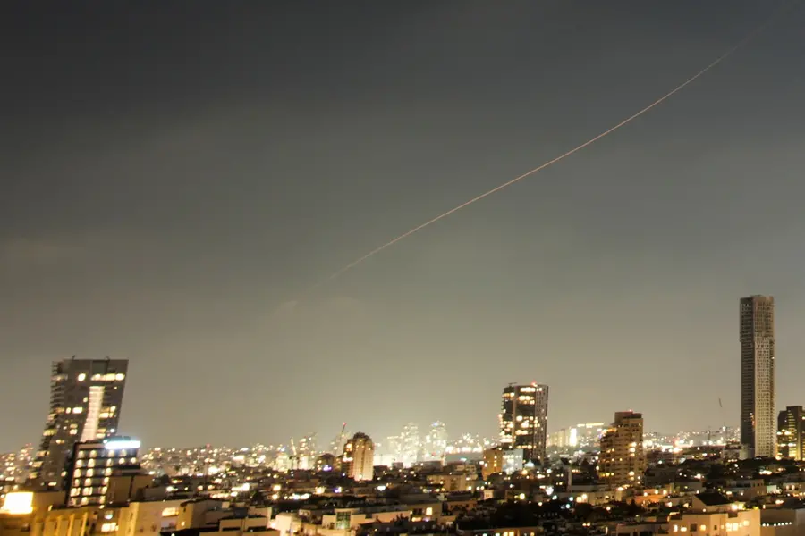 A projectile streaks through the sky over central Israel during an Iranian missile attack