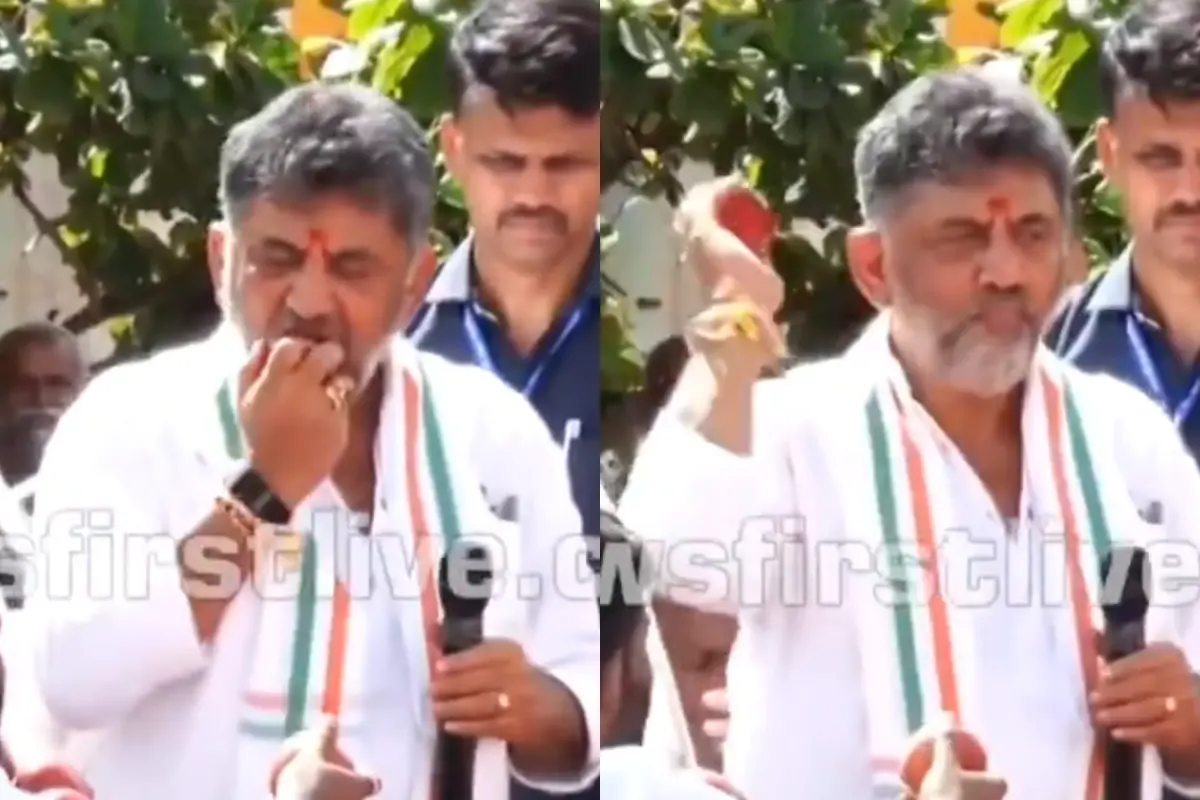 Karnataka CM DK Shivakumar biting an apple and tossing apples into a crowd