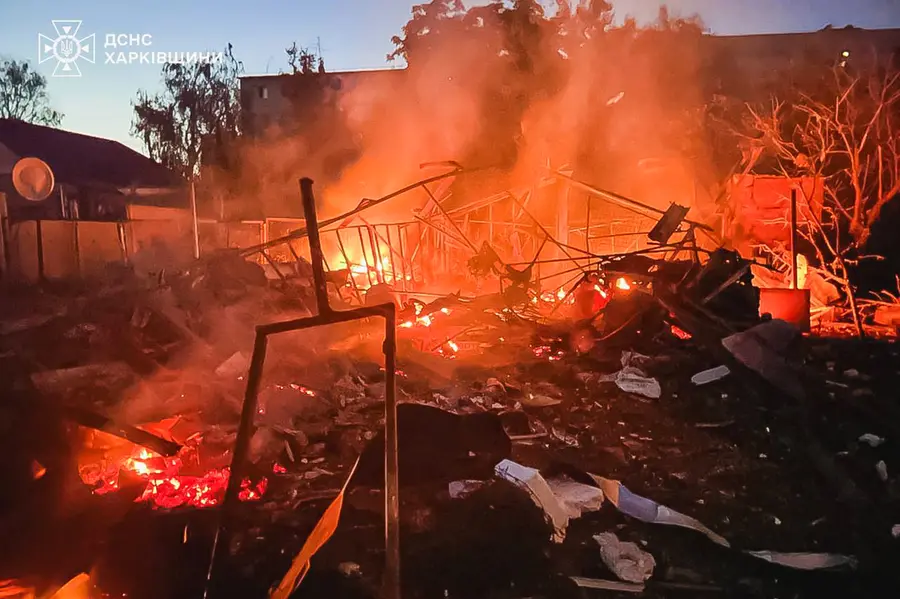 A damaged building burns after a Russian strike in Kharkiv, Ukraine