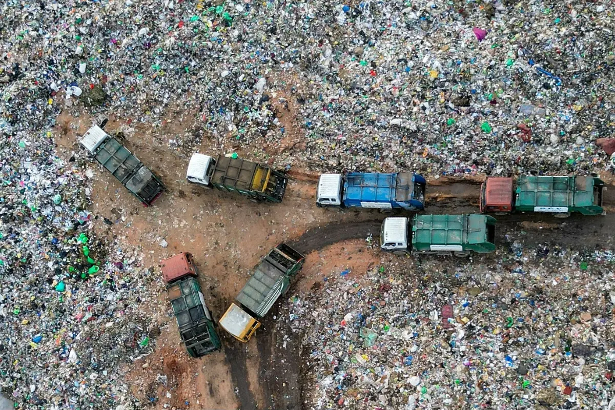 An aerial view shows municipal trucks of Bruhat Bengaluru Mahanagara Palike (BBMP), as they unload garbage at a landfill on the outskirts of Bengaluru.| Photo: AFP