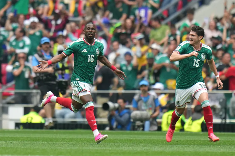 Mexico's Julian Quinones (16) celebrates scoring their opening goal against South Africa