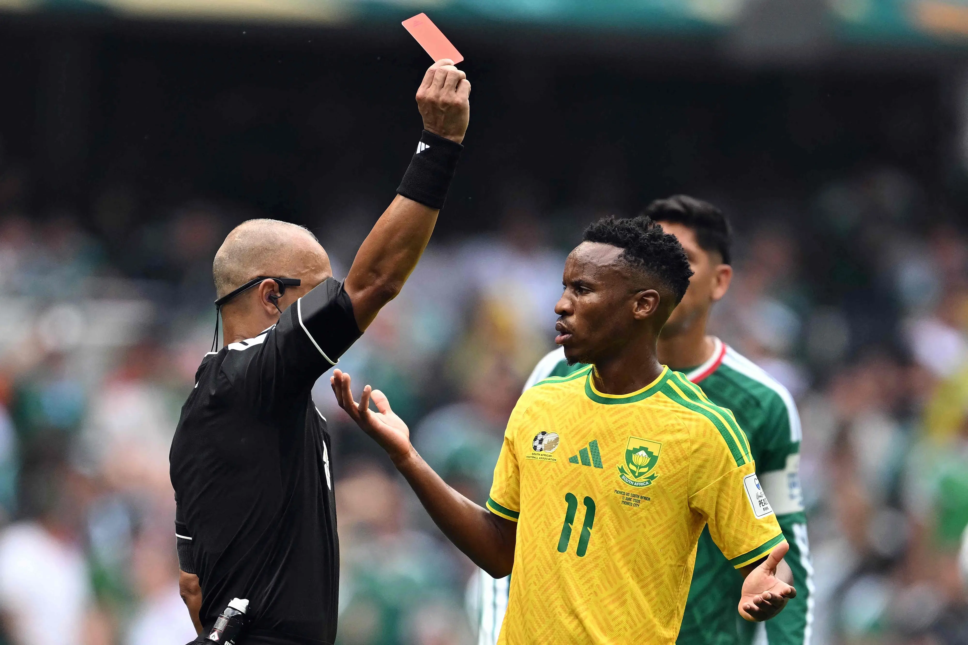Brazilian referee Wilton Sampaio shows a red card to South Africa's midfielder Themba Zwane | AFP