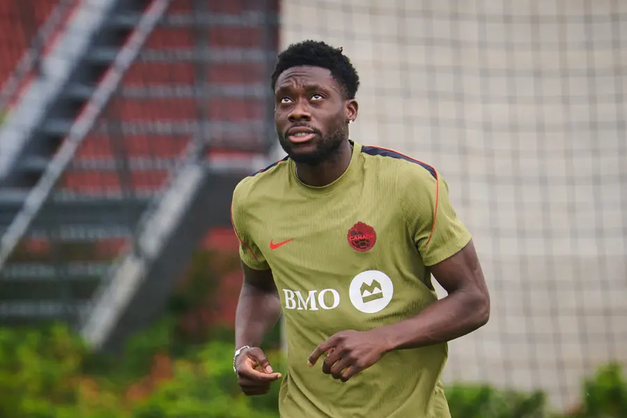 Canada's Alphonso Davies runs laps during a World Cup training session in Toronto