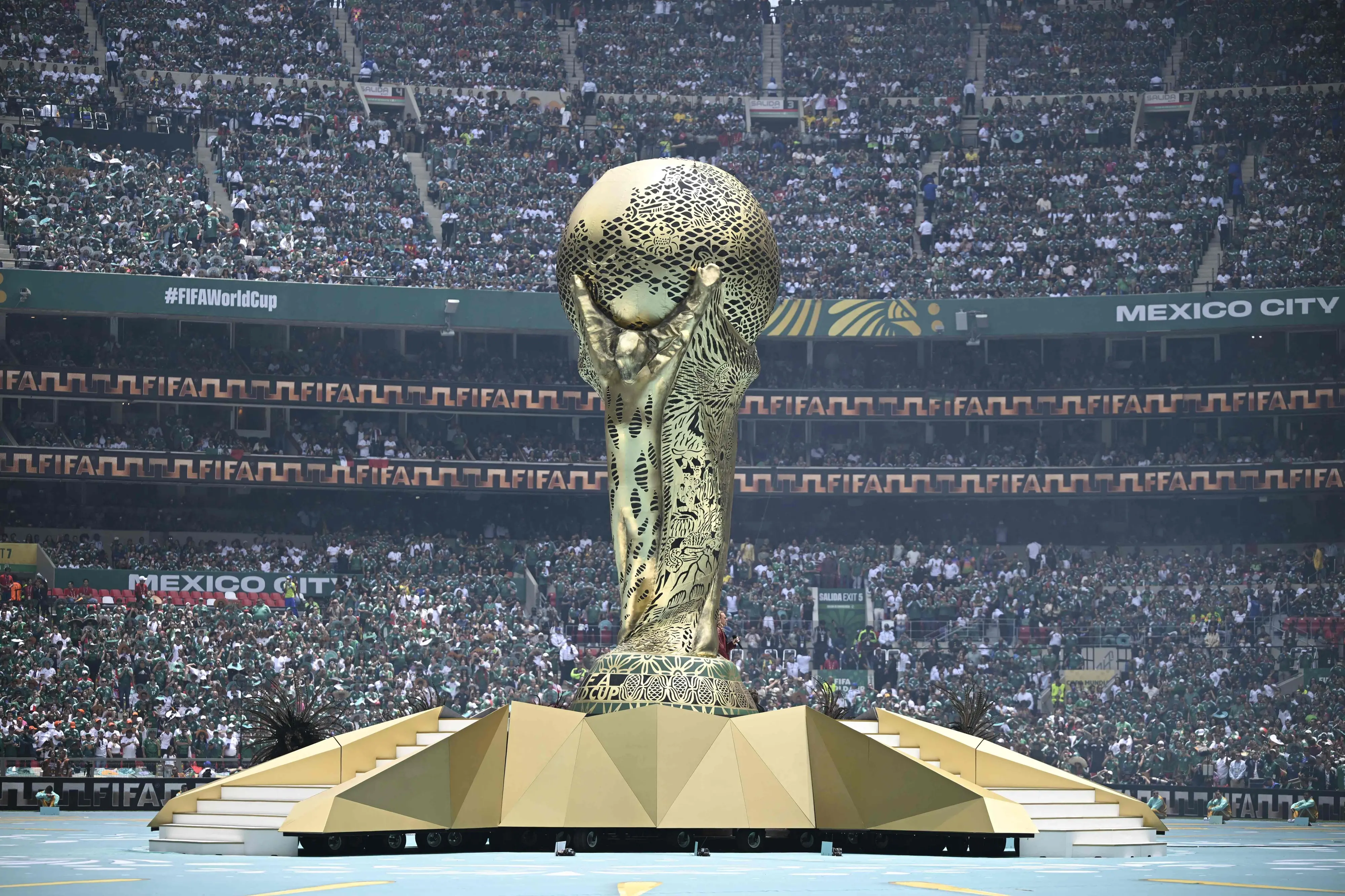 A huge replica of the World Cup trophy is seen during the opening ceremony ahead of the 2026 World Cup Group A football match between Mexico and South Africa at the Mexico City Stadium in Mexico City | AFP