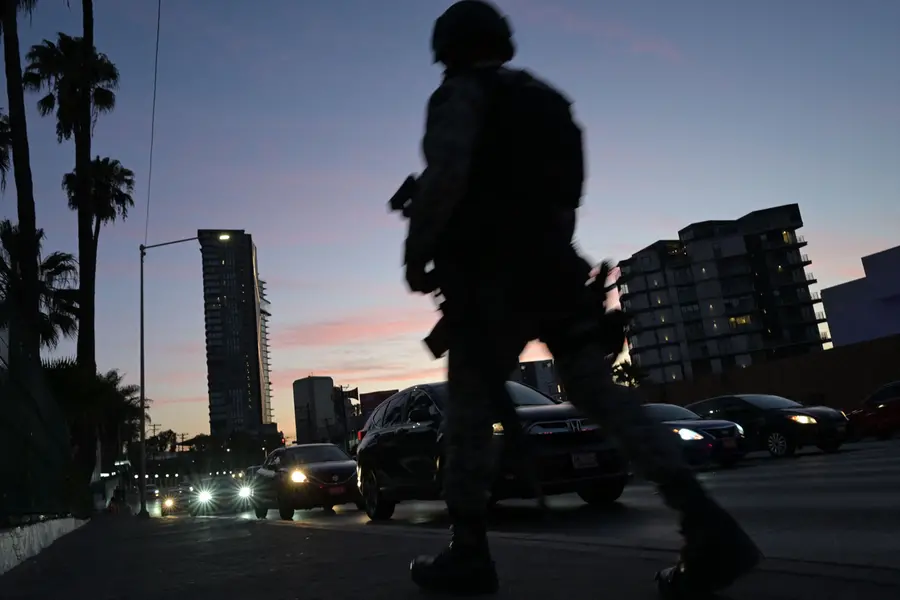 A member of Mexico's National Guard remains outside the hotel where Iran's national football team is staying in Tijuana, Mexico