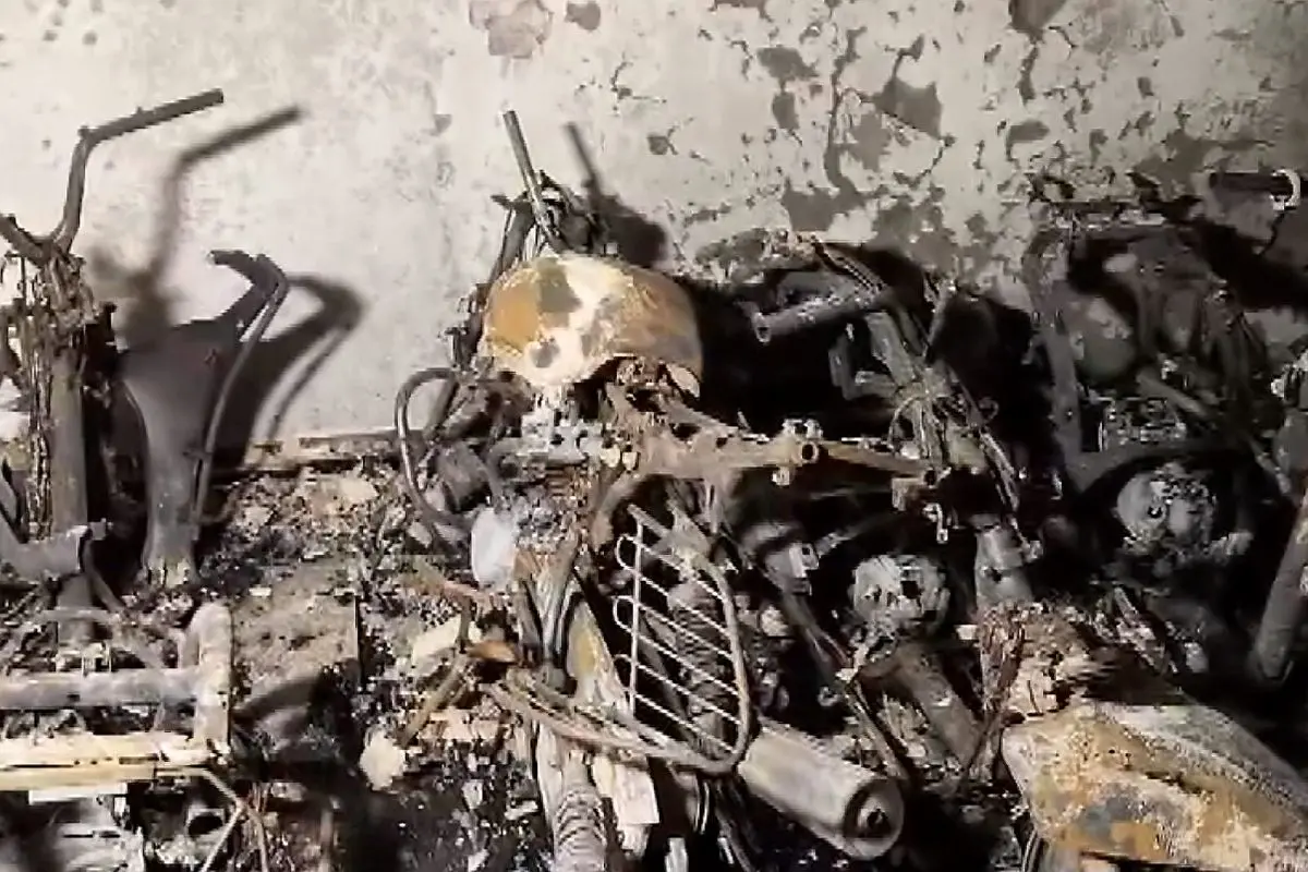 Charred remains of two-wheelers and bicycles are seen after a fire broke out in a five-storey residential building at Tughlakabad Extension area, in New Delhi, Friday, June 12, 2026 (Photo: PTI)