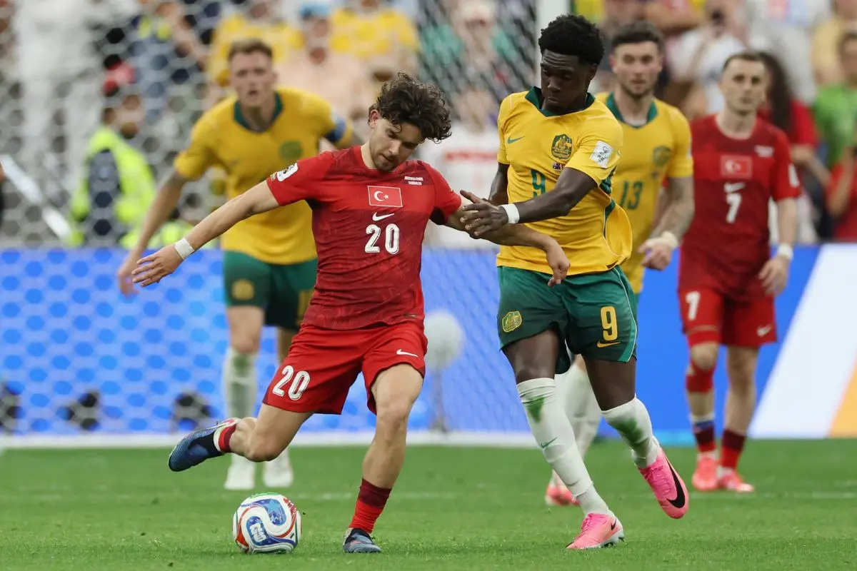 Turkey's Ferdi Kadioglu (20) works past Australia's Mohamed Toure (9) during the World Cup Group D soccer match in Vancouver, British Columbia, Saturday, June 13, 2026. (AP Photo/Sydney Shankman)