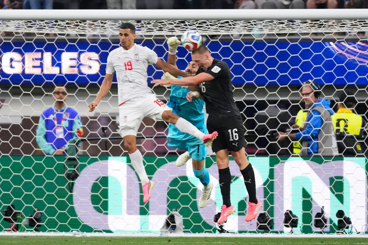 Iran goalkeeper Alireza Beiranvand (1) defends the goal alongside Ali Nemati (19) and New Zealand's Finn Surman (16) during the World Cup Group G soccer match between Iran and New Zealand in Inglewood, Calif., near Los Angeles.| Photo: AP