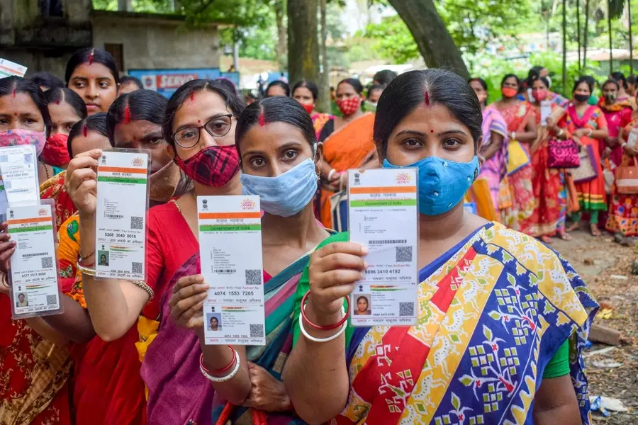 People showing their Aadhaar Card