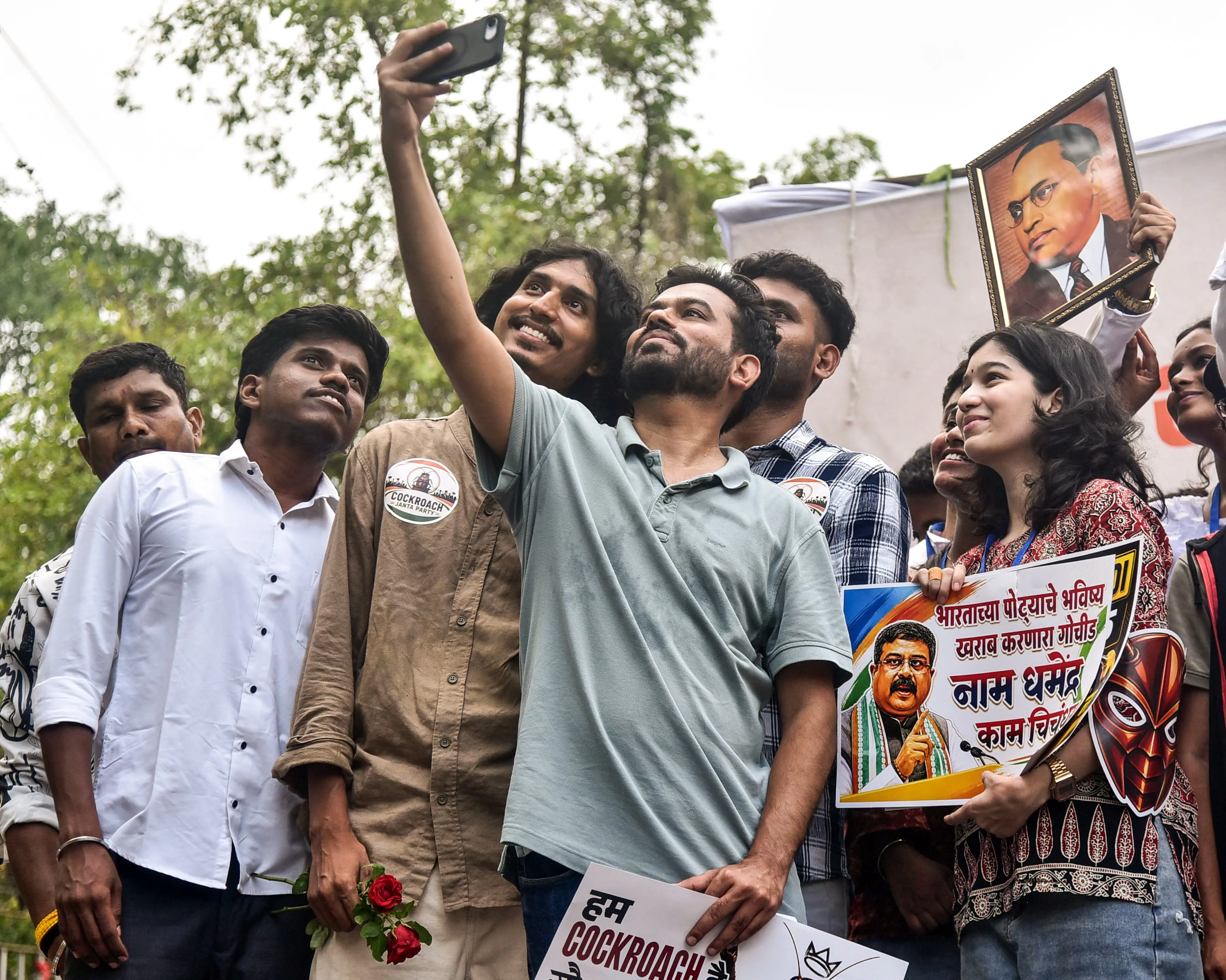 Cockroach Janata Party (CJP) founder Abhijeet Dipke clicks a group selfie during a demonstration over the NEET-UG paper leak row and various issues at Samvidhan Chowk, in Nagpur | ANI