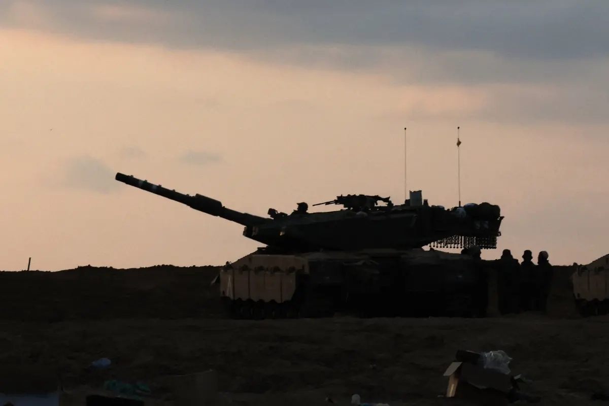 Israeli soldiers are positioned alongside their armoured vehicles near the border.| Photo: AFP