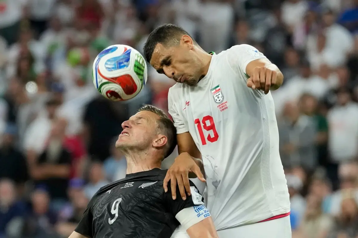 Iran's Ali Nemati (19) battles for the ball with New Zealand's Chris Wood (9) during the World Cup Group G soccer match between Iran and New Zealand in Inglewood, Calif., near Los Angeles. | Photo: AP/PTI