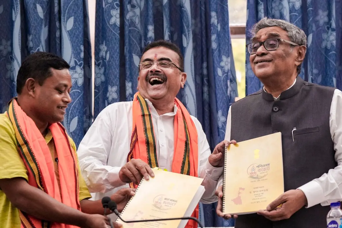 West Bengal Chief Minister Suvendu Adhikari and State Finance Minister Swapan Dasgupta display copies of the state Budget after its presentation in the West Bengal Legislative Assembly, in Kolkata, Monday, June 22, 2026. (PTI Photo/Swapan Mahapatra)