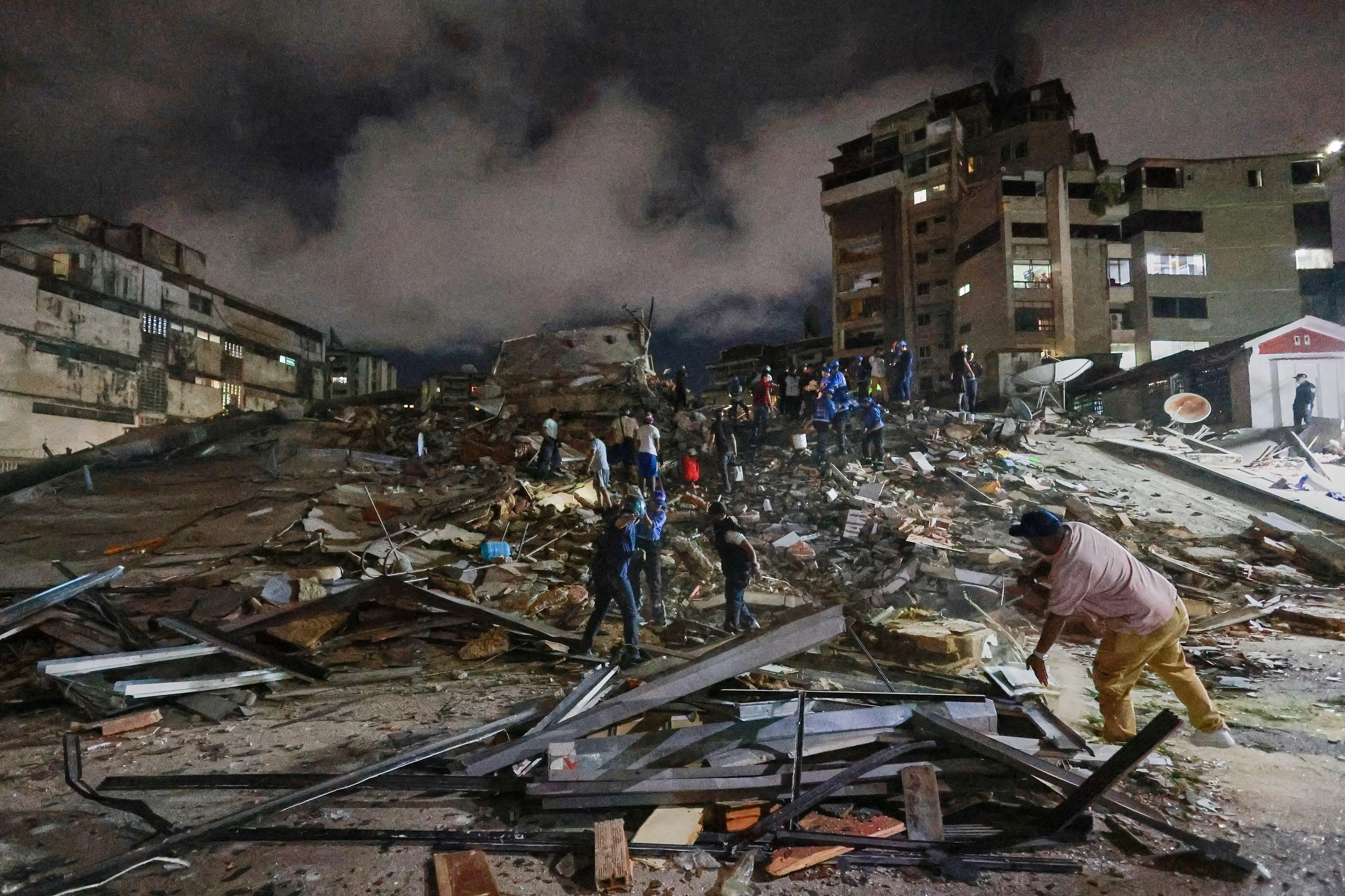 Rescue workers search through the rubble after an earthquake in Caracas, Venezuela, Wednesday, June 24, 2026. (AP Photo/Javier Campos)