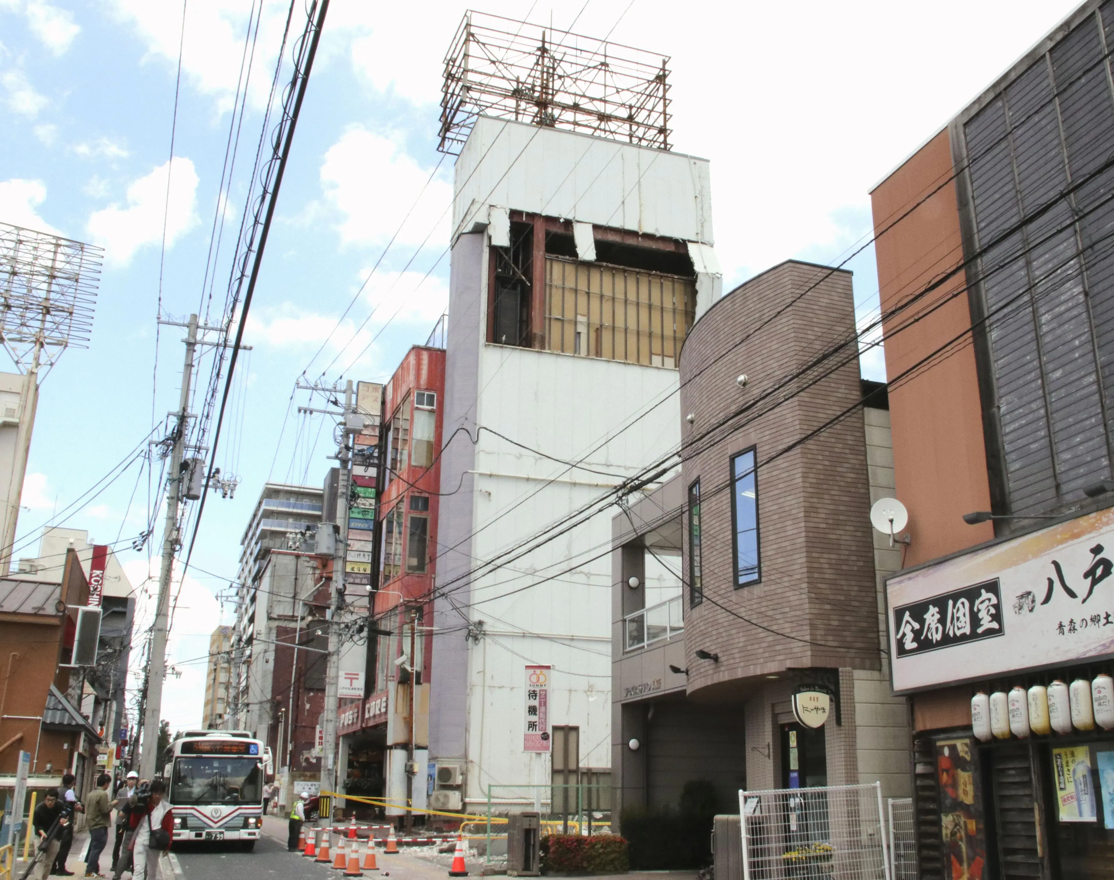 The wall of a building is seen partly damaged following an earthquake in Hachinohe | AP