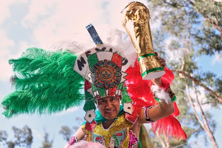 A Mexico fan holds a copy of the World Cup trophy outside the stadium