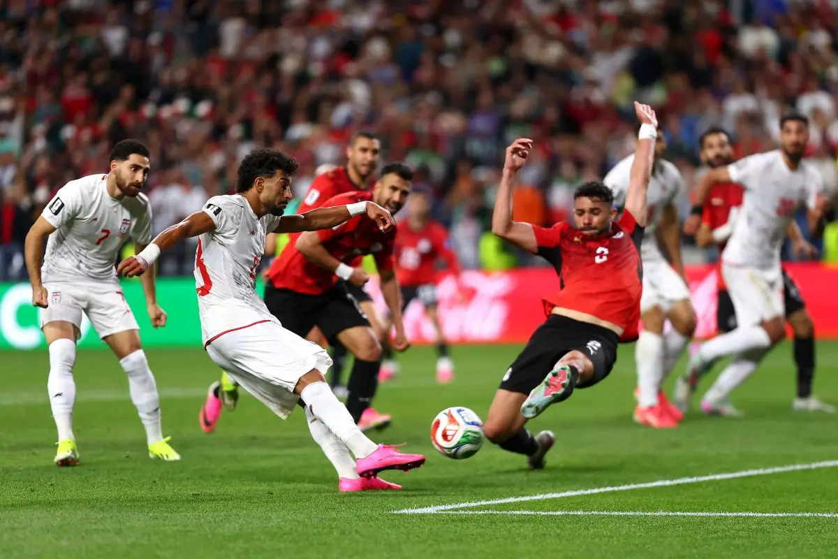 Ramin Rezaeian of Iran shoots and misses a chance against Yasser Ibrahim of Egypt. (Photo: AFP)