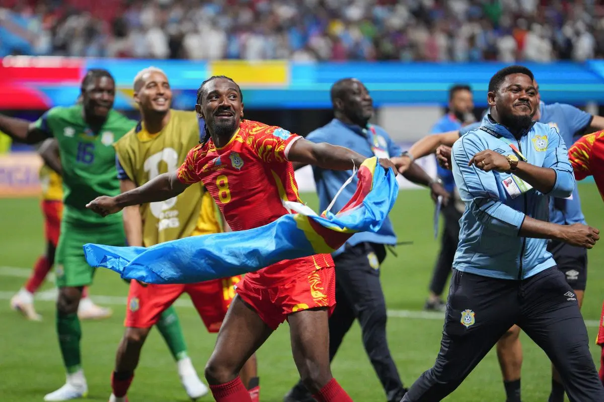 Congo's Samuel Moutoussamy (8) joins other teammates, coaches, and stff in celebrating a win after the World Cup Group K soccer match between DR Congo and Uzbekistan in Atlanta, Saturday, June 27, 2026. (AP Photo/Jacob Kupferman)