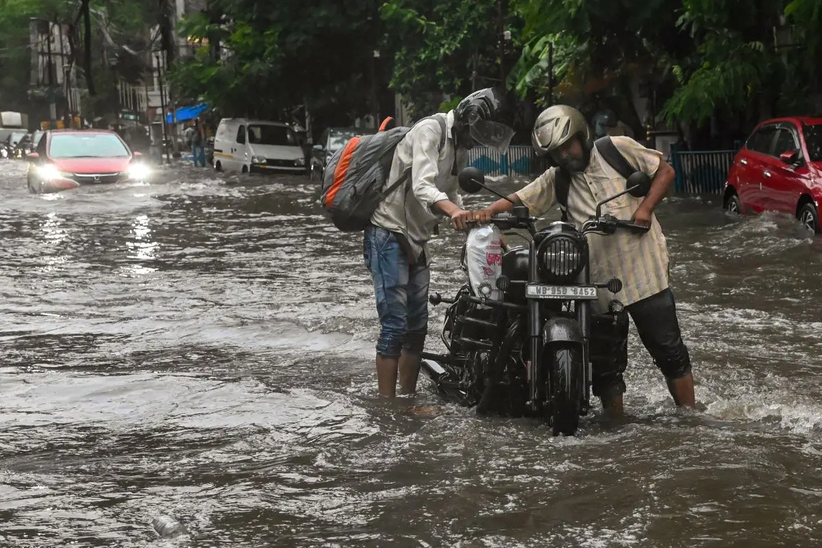 Kolkata: People wade through a waterlogged road after rainfall, in Kolkata, West Bengal, Thursday, June 25, 2026. (PTI Photo)