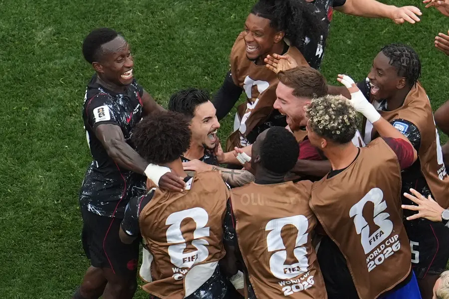 Canada's Stephen Eustaquio, 2nd left, celebrates with teammates after scoring his side's opening goal