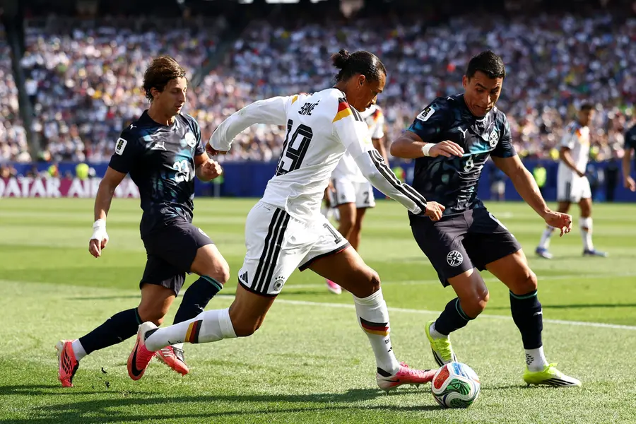 (L-R) Paraguay's midfielder Matias Galarza, Germany's forward Leroy Sane, and Paraguay's defender Junior Alonso