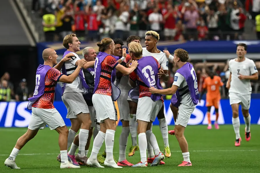 Antonio Nusa (C) celebrates with teammates after scoring the opening goal | AFP