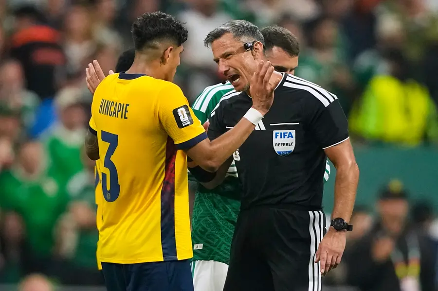 Referee Slavko Vincic of Slovenia speaks to Ecuador's Piero Hincapie (3) before sending him from the field during the World Cup round of 32 soccer match between Mexico and Ecuador